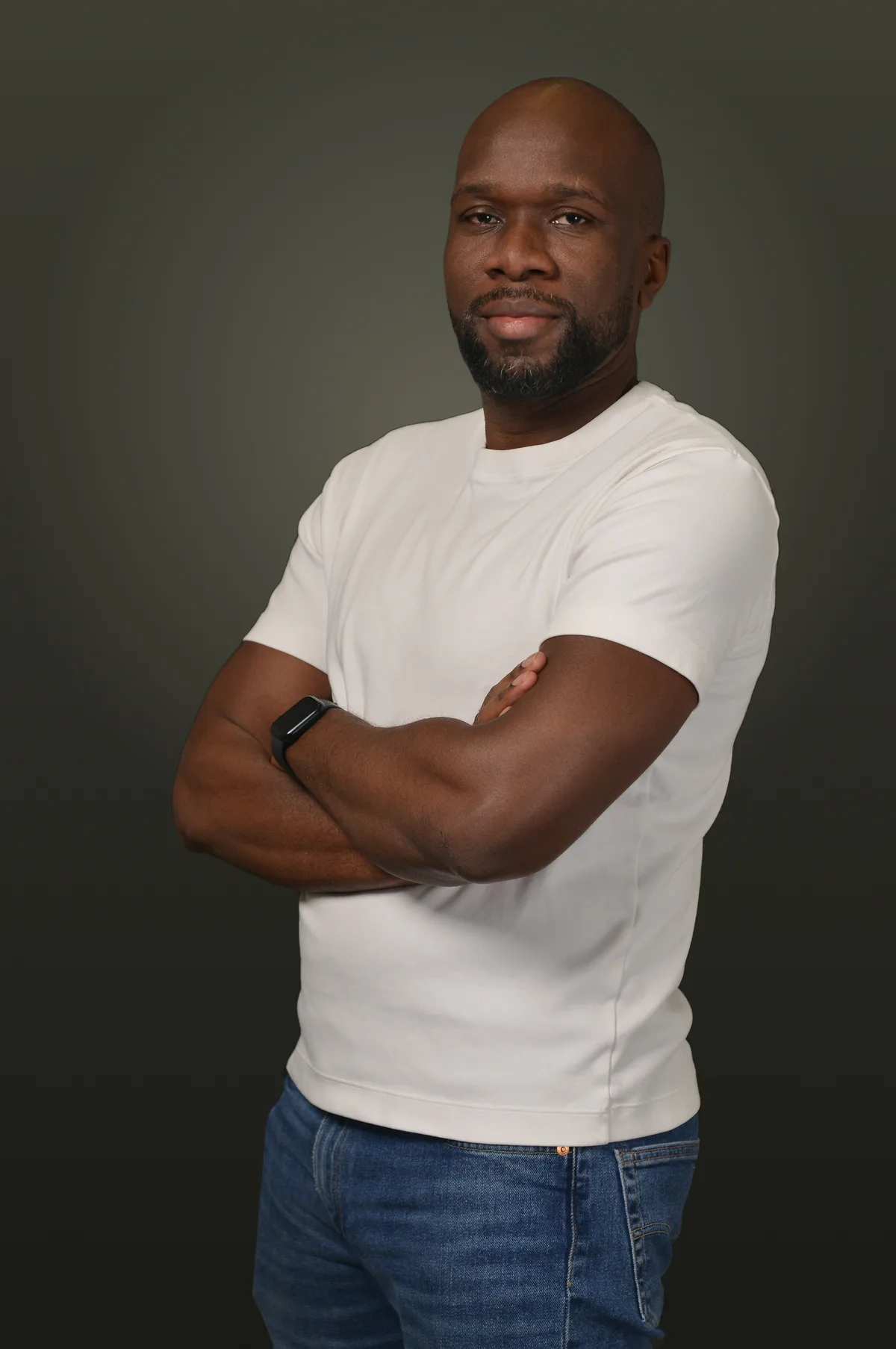 Kanyanta Mubanga looking at the camera, wearing a white T-shirt