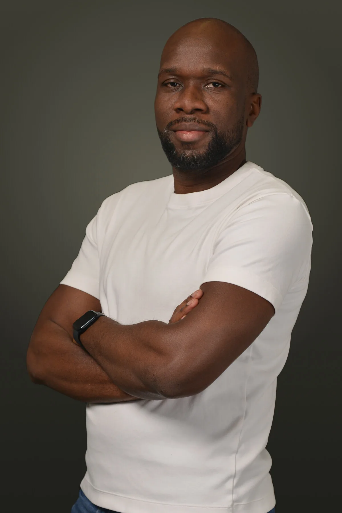 Kanyanta Mubanga, photographed in a white T-shirt against a dark background